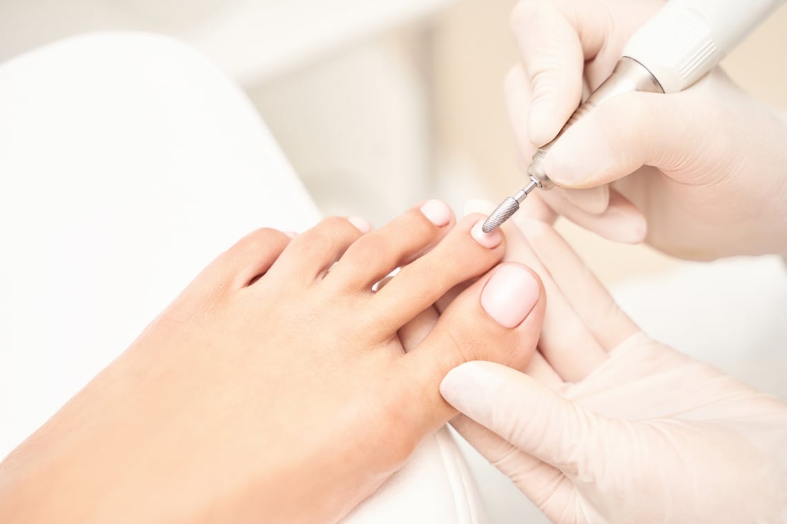 Classic Pink Wedding Toe Nail Manicure on White Backdrop. Spa Treatment Concept